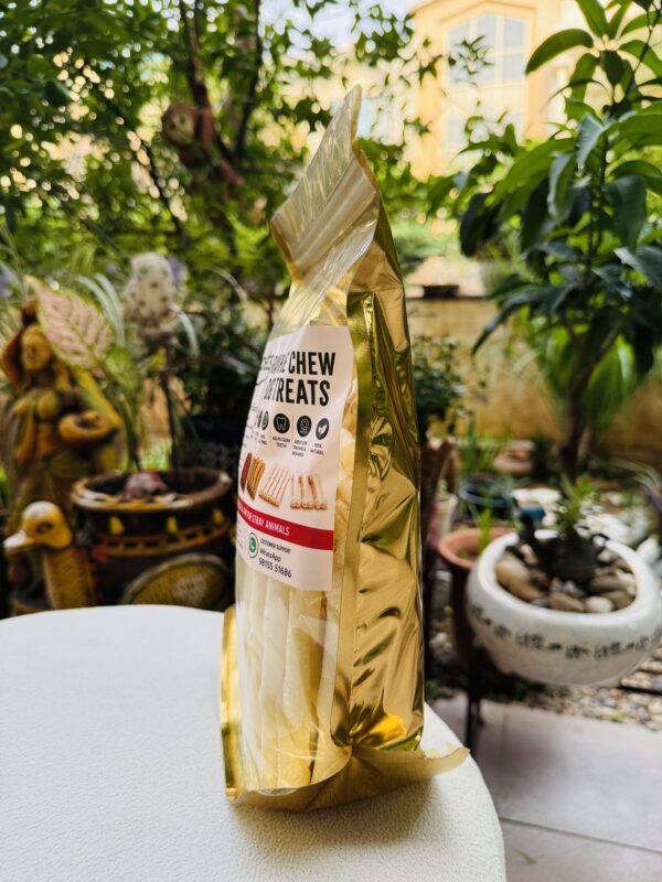 Dog treat milky sticks in golden pouch
